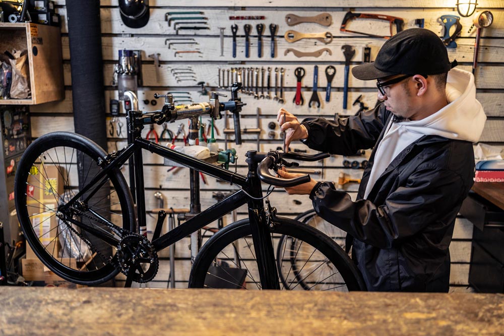 medium-shot-man-repairing-bike
